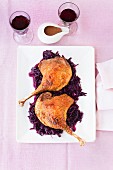 Goose legs on a bed of orange red cabbage (seen from above)
