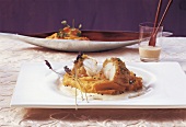 Monkfish with parmesan cheese crust and lavender sauce in serving dish