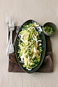 Wide rice noodles with broccoli, grated coconut and chilli