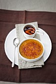 Creme brulee with espresso and pepper served with damson compote