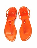 Orange thong sandals on white background
