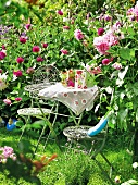 Small table with chairs surrounded by dahlia plants, garden kitchen
