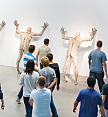 Visitors looking at human figures at Zagreb museum, Croatia