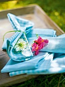 Close-up of flowers on blue napkin, garden kitchen