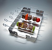 Kebab set of stainless steel on gray background