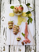 Rabbit meat and potatoes skewers on chopping board