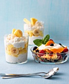 Glasses of couscous with fruit and coconut and pineapple rice pudding in glass dish