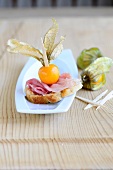 Ham canapes on plate