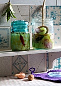 Homemade pickled gherkins with onions in jars