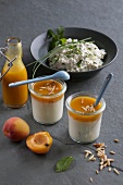 Yogurt with apricot puree and herb quark in jars