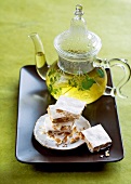 Close-up of homemade white nougat and mint tea on tray
