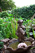 Fountain with child figurine in garden