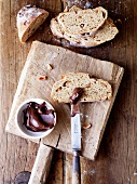 Slice of peanut bread on chopping board with chocolate spread