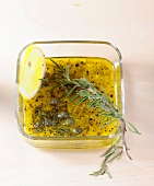 Rosemary and lemon marinade in glass bowl