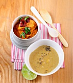 Red lentil dip and peanut-coconut dipping sauce in bowls