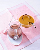 Rum and cocoa cream in jug with peanut caramel sauce in glass bowl 
