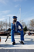 Wooden figure at orth harbor in Baltic coast, Fehmarn, Schleswig-Holstein, Germany