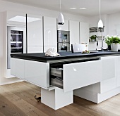 View of modern kitchen with white furniture and cutlery drawer