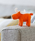 Close-up of stuffed moose on sofa