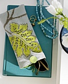Close-up of spectacle in handmade cover with floral motif on book
