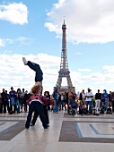 Street artists performing hip hop in front of Eiffel Tower, Paris, France