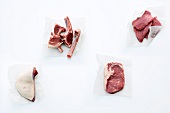 Beef steak, lamb chops and veal cutlets on white background