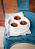 Oxtail broth in cups on a chair