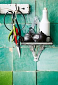 Scissors, chillies & various vessels on kitchen wall