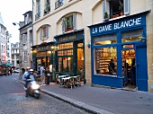 View of cafe and shops on roadside in Paris, France