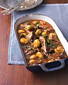 Hare stew with mushrooms in baking dish