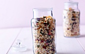 Close-up of muesli in glass jar on white background