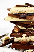 Stack of pieces of various chocolate bars, close-up