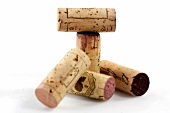 Close-up of five corks on white background