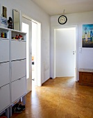 White shoe cabinet in room with wooden floor