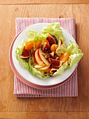 Fruit salad with walnuts on plate