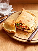 Close-up of calzones with wild mushrooms on chopping board