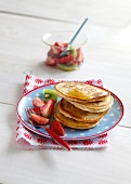 Pancakes with strawberry salad on plate