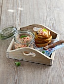 Bread crisps with tomato dip in wooden tray