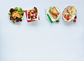 Four varieties of snacks on white background