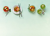 Four varieties of soups on green background