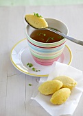 Cup of beef broth with semolina dumplings on tissue paper
