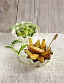Potato wedges with avocado dip in small bowls