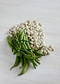 Green and white broad beans on plate