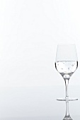 Glass of mineral water on white background