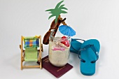 Sunglasses, flip flops, passport, deck chair, palm tree and jar full of sand