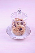 Muesli in glass jar on plate, low GI diet food