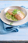 Bowl of salmon fillet with cucumber on plate, low GI diet food