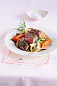Noisette of lamb with herbs on a bed of vegetables