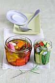 Spicy preserved peppers and courgette in jars