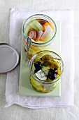 Two glass jars of Japanese pickle made from olive and feta cheese in oil, low GI diet food